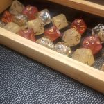 3 sets of honey themed dice in a custom dice tray