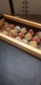 3 sets of honey themed dice in a custom dice tray